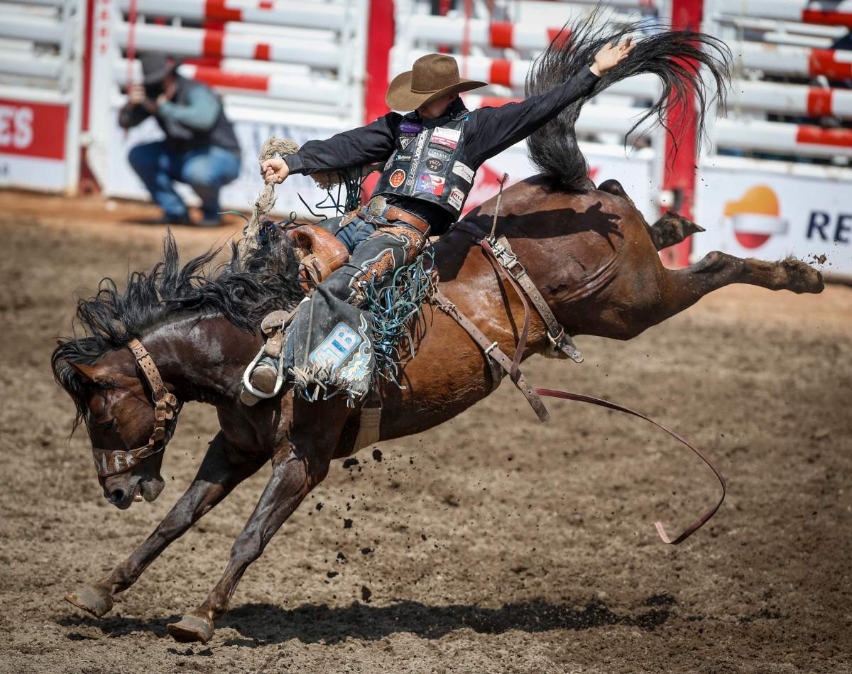 Zeke Thurston, of Big Valley, Alta., rides Centre Stage during saddle bronc rodeo action at the Calgary Stampede on Saturday, July 6, 2019.