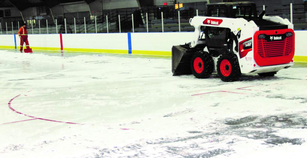 The ice at the Claresholm Arena being removed by public works staff.