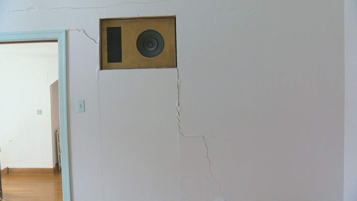 Cracks are seen in the home’s stucco walls.
