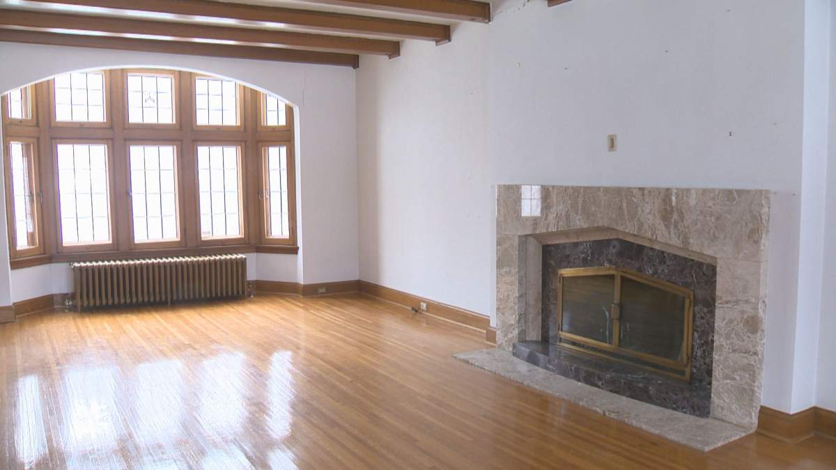A grand fireplace can be seen in one of the home’s living rooms.