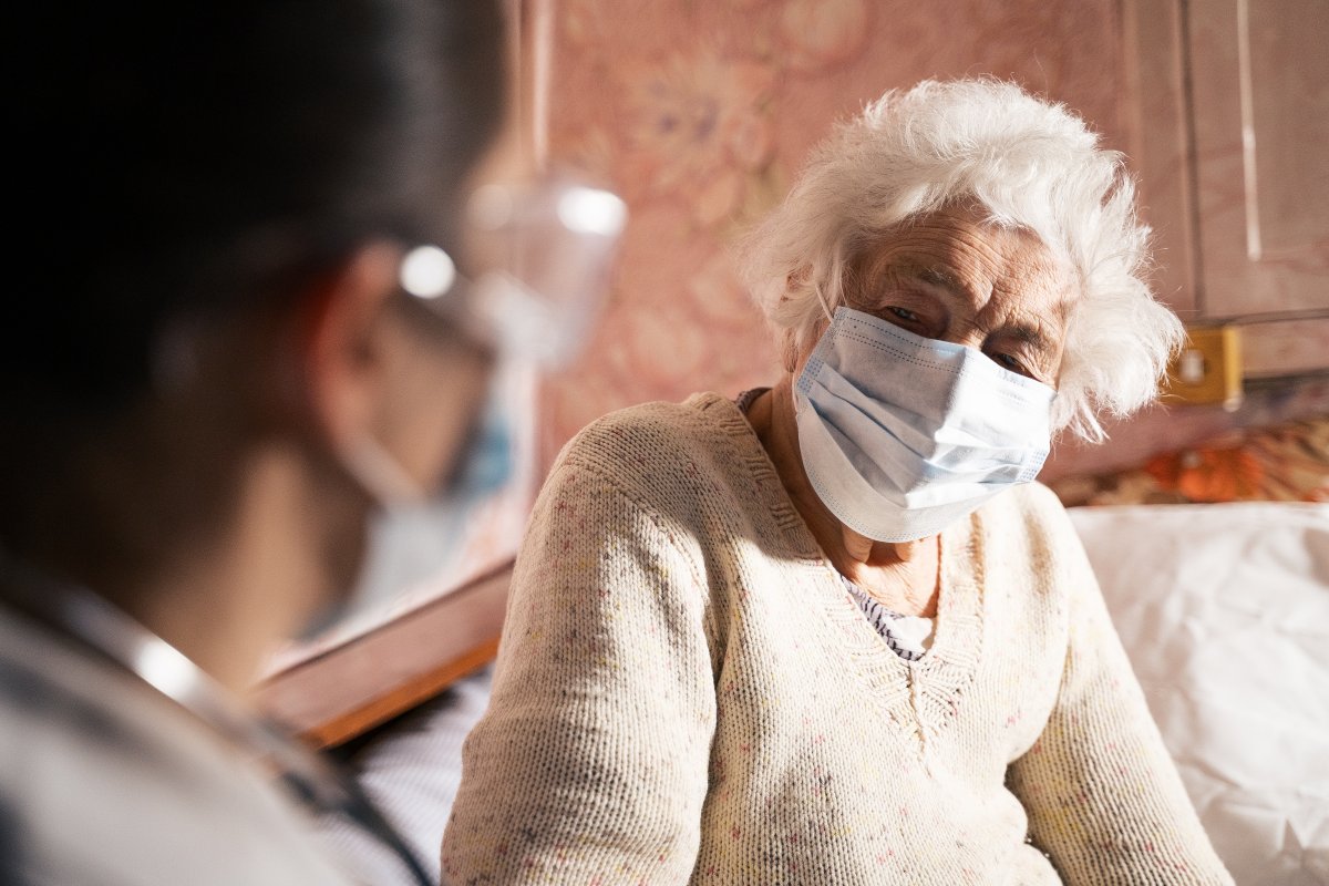 A doctor doing medical exam of a senior woman.