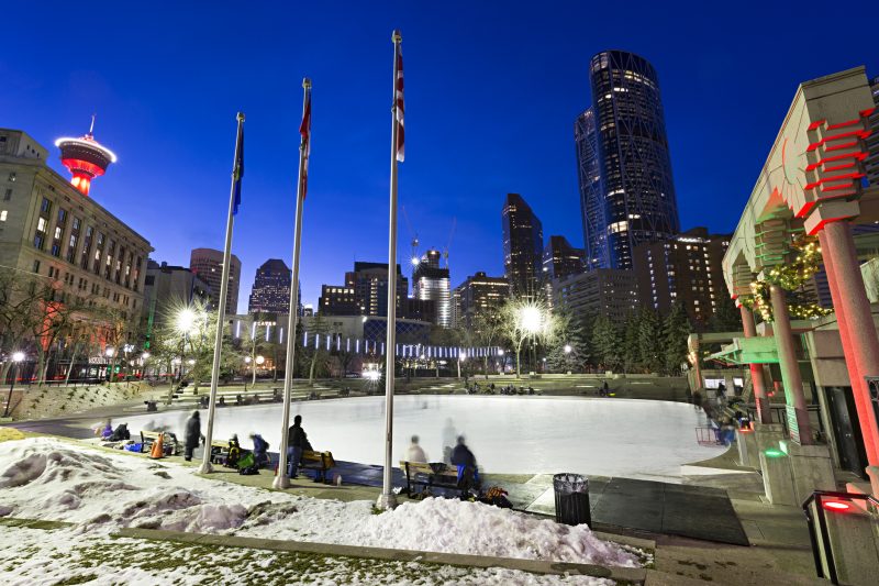 People enjoy the outdoor ice rink at Olympic Plaza in downtown Calgary. 