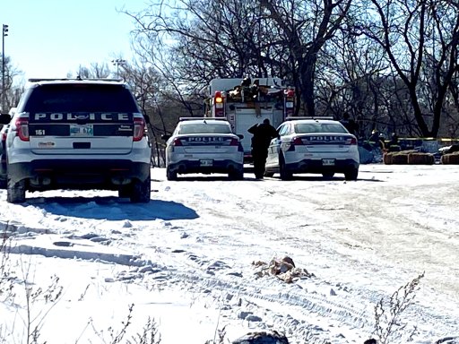 Police and first responders at the scene of the aftermath of a homeless camp fire in Winnipeg on Tuesday, Feb. 16.
