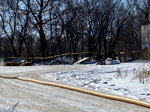 Police tape around the scene of the aftermath of a homeless camp fire in Winnipeg on Tuesday, Feb. 16.