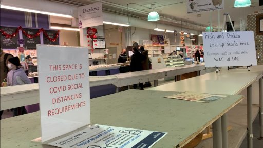 A sign inside The Fredericton Boyce Farmers Market explains why the middle isle is lacking vendors