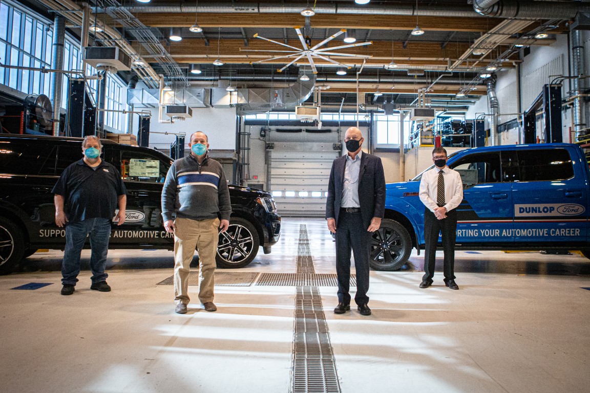 Left to right: Kevin Wiber, Chair, Cooks School of Transportation; Sheldon Anderson, Dean, Centre for Trades; Gary Dunlop, President, Dunlop Ford; Andy Brayne, Service Manager, Dunlop Ford pose with the two donated Ford of Canada vehicles.