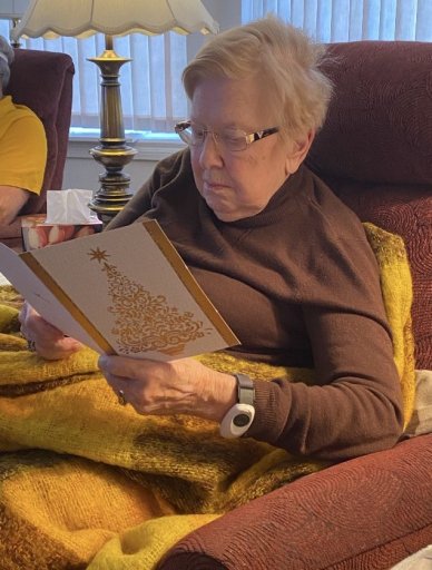 Image of Pauline reading the card Allan wrote to her.