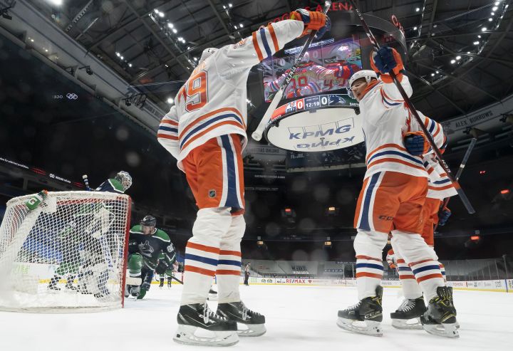 Edmonton Oilers right wing Alex Chiasson, centre right, celebrates his goal against the Vancouver Canucks with teammate Leon Draisaitl, left, during second period NHL action in Vancouver, Thursday, February 25, 2021.