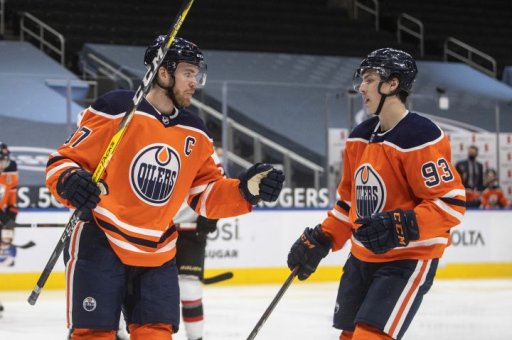 Edmonton Oilers’ Connor McDavid (97) and Ryan Nugent-Hopkins (93) celebrate a goal against the Ottawa Senators during second period NHL action in Edmonton on Sunday, January 31, 2021.