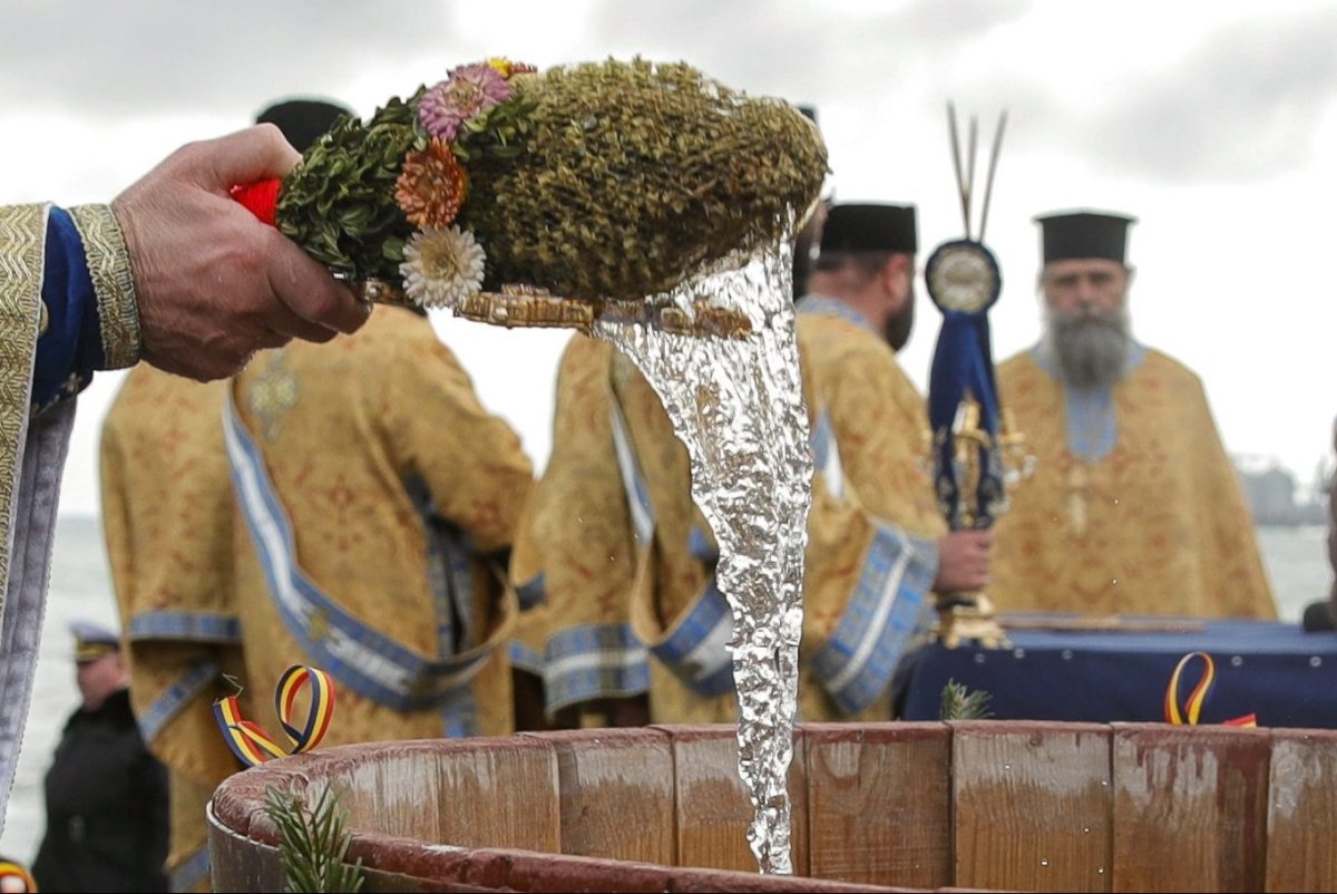 In this file photo, Orthodox archbishop Teodosie blesses water during an Epiphany religious service in Constanta, Romania, Monday, Jan. 6, 2020. 