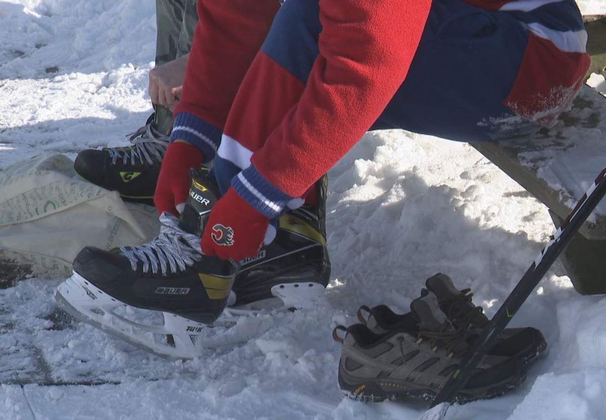 Lacing up skates in the Calgary cold on Saturday, Feb. 13, 2021.