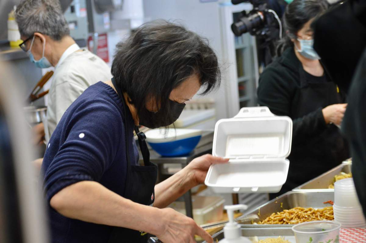 Pi Yeng Chen serves up food at the Seaport Farmer’s market on Sunday, Jan. 31, 2021