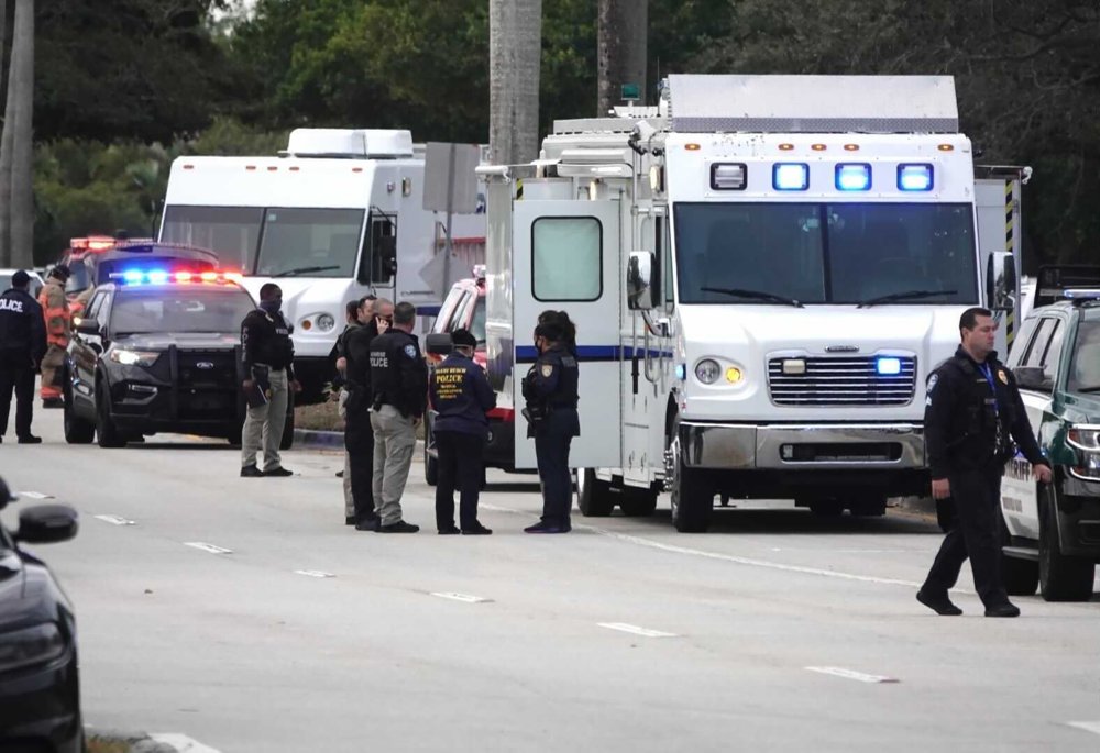 Law enforcement gather near the scene of a shooting that wounded several FBI agents in Sunrise, Fla., Tuesday, Feb. 2, 2021.