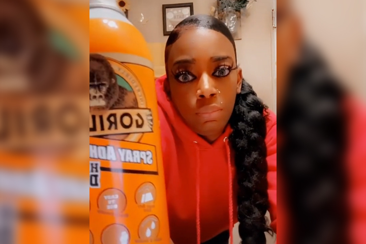 Tessica Brown is shown with a can of Gorilla spray adhesive that she used to style her hair, in this image from a TikTok video.