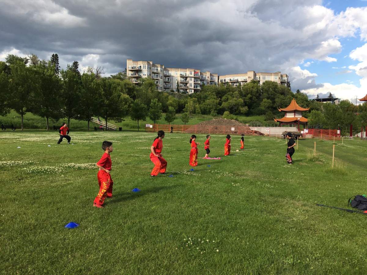 Students from Edmonton Hung Mon Athletic Club practising outdoors.