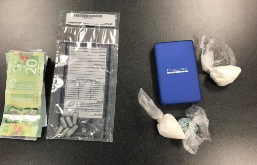Police seized drugs, cash and a scale during the arrest of a man for failing to attend court.
