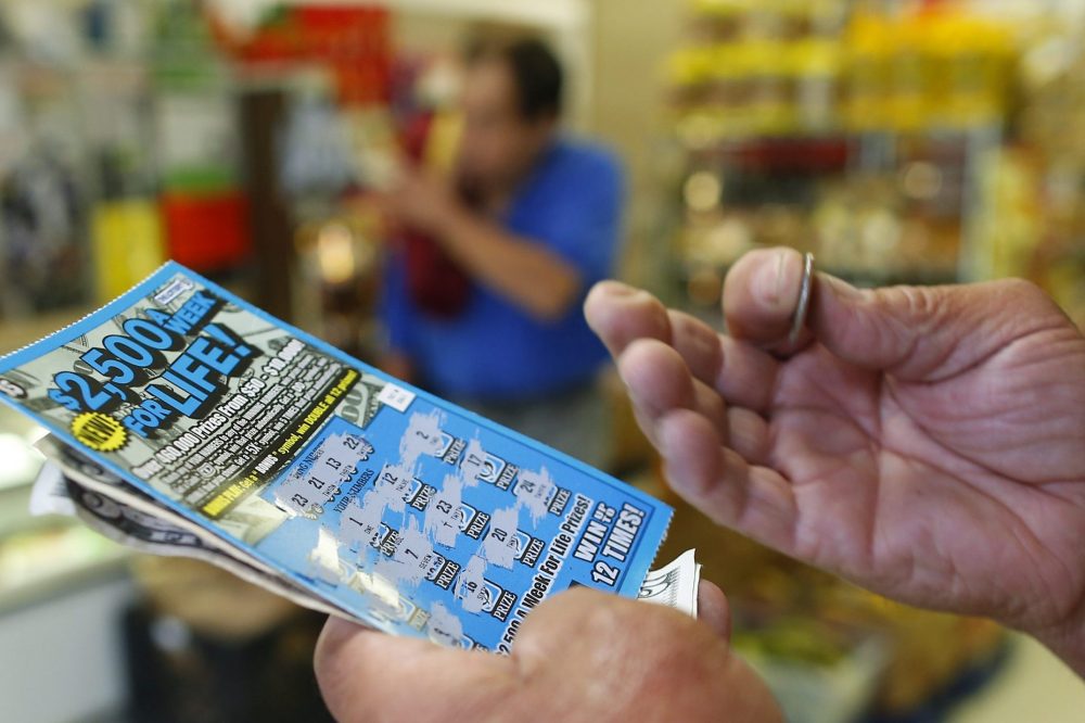 A person plays a scratch card in this file photo from June 4, 2014.