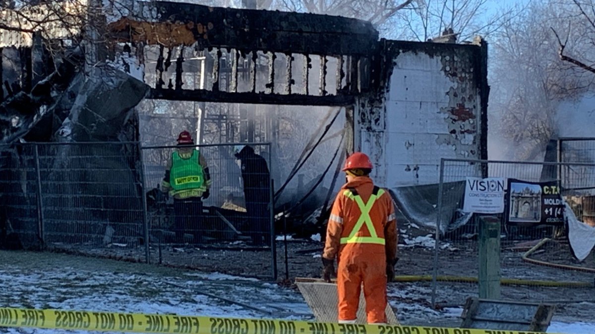 Fire crews look over damage from a blaze at a home on Wood Place in Oakville on Thursday Feb. 4, 2021.