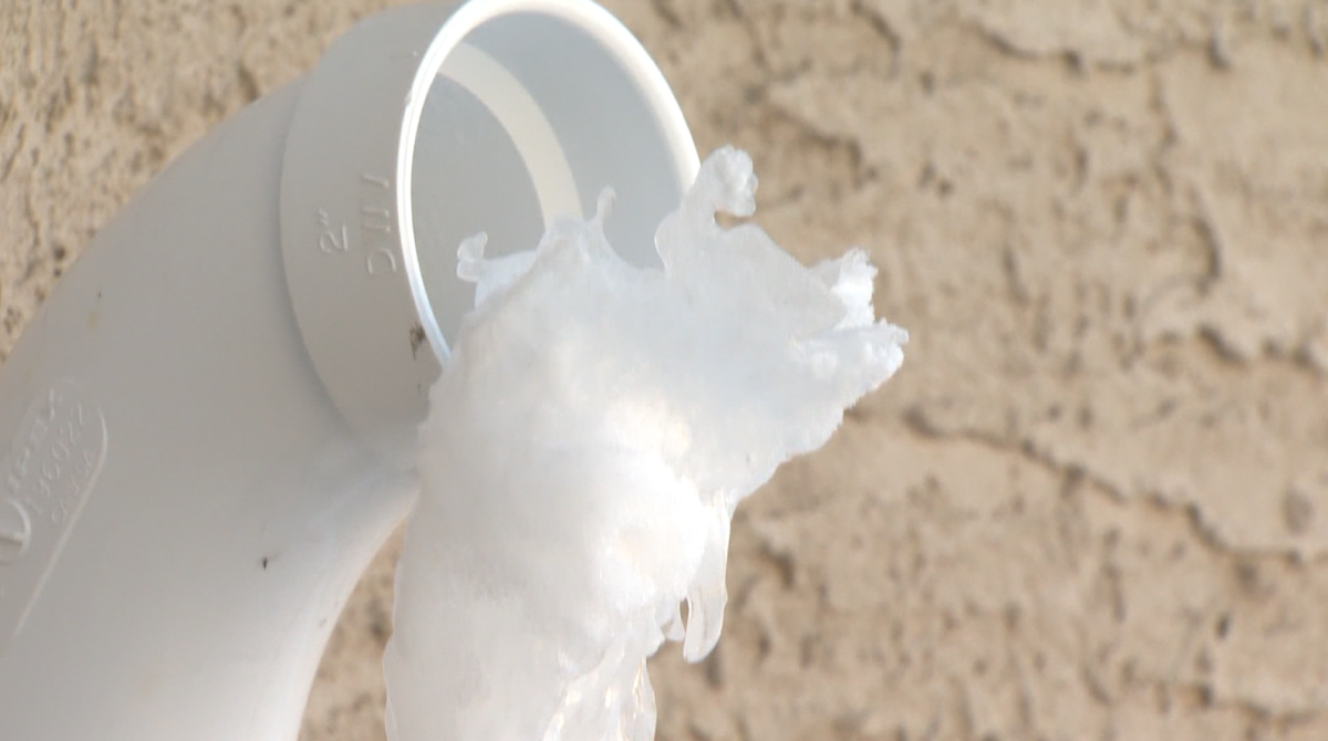 Ice overflowing from a residential pipe in Winnipeg.