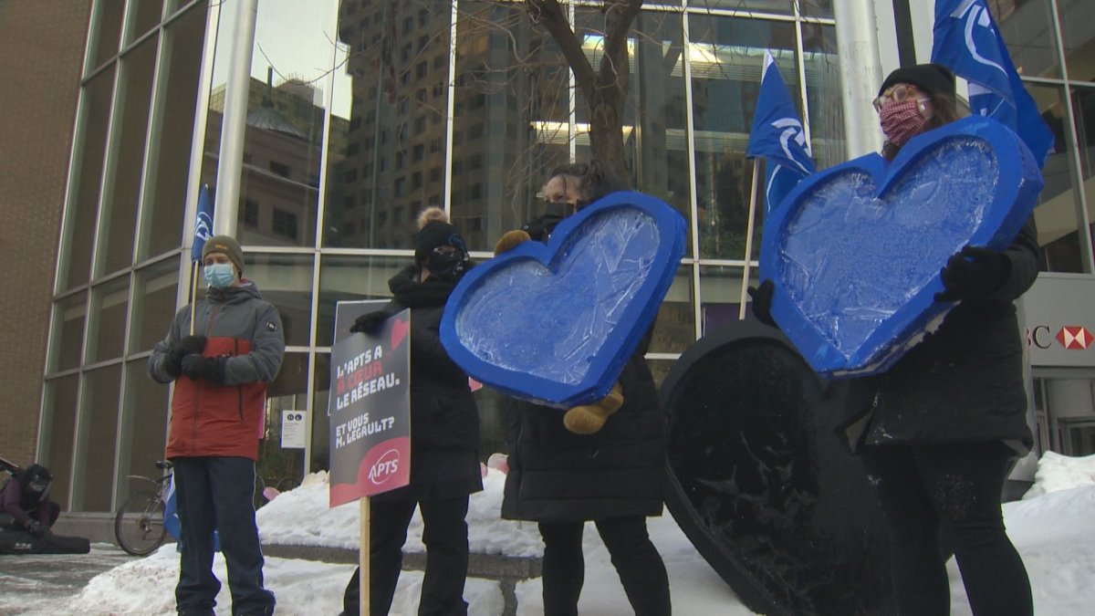About a dozen  health professionals demonstrated outside Premier Francois Legault's Montreal office Thursday.