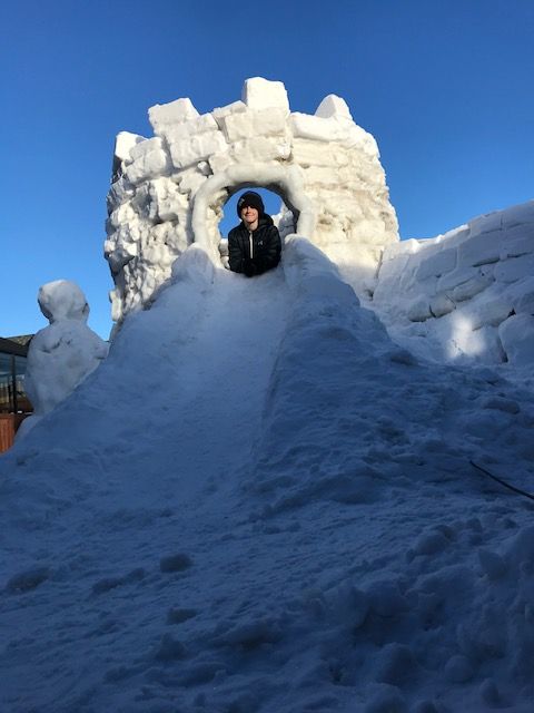 Sebastian McCarthy enjoys his handy work after building a pair of igloos in his Lloydminster, Alta., backyard.