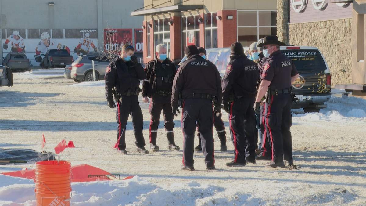 Calgary police investigate on Saturday, Feb. 20, 2021, after a body was found in a parking lot along Macleod Trail.