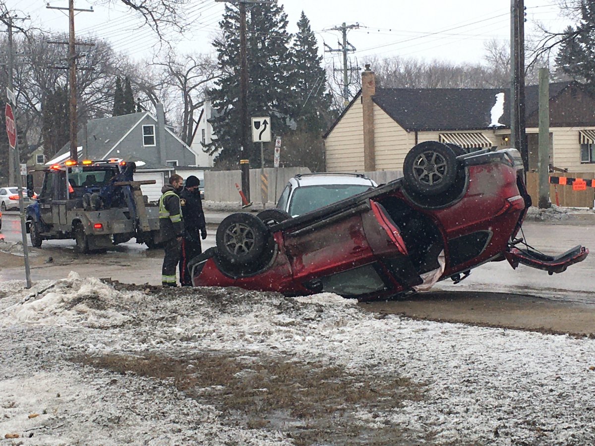 Police and a tow truck survey the scene at Ness Avenue and Moorgate Street Friday afternoon.