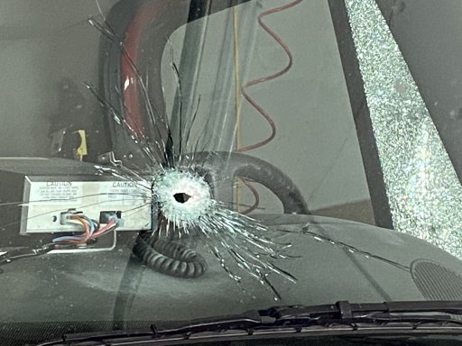 Image of bullet hole in the windshield of an Onslow Belmont Brigade firetruck.