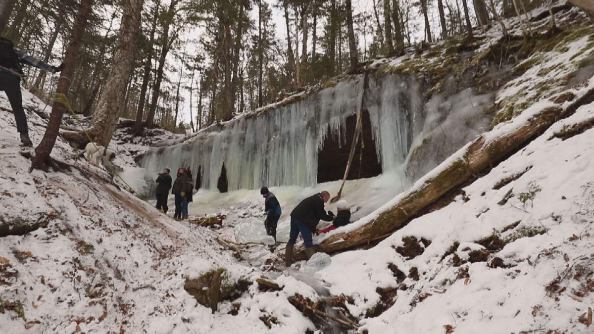 Falling water freezes each winter, forming caves in the space below the embankment.