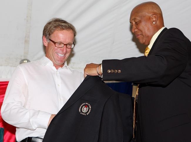 Rheal Cormier receives his jacket from Ferguson Jenkins during his induction to the Canadian Baseball Hall of Fame, Saturday June 23, 2012 in St. Marys, Ontario. Born in Cape Pele, N.B. Cormier pitched for 16 big-league seasons, the third most by a Canadian. 