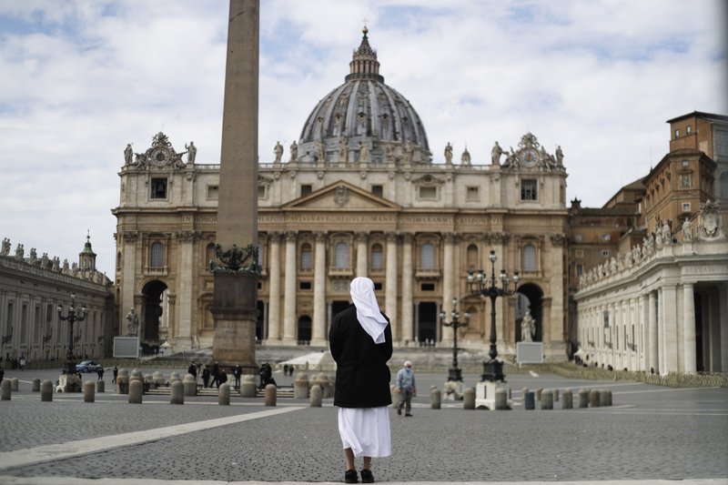 A nun stands in St. Peter's Square at the Vatican, Sunday, March 21, 2021. Pope Francis has denounced racism, likening it to a virus that lurks in waiting and continues to be shameful. Francis in a tweet on Sunday called racism “a virus that quickly mutates and, instead of disappearing, goes into hiding, and lurks in waiting.” .