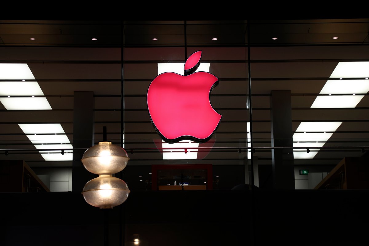 FILE - In this Sunday, Dec. 6, 2020 file photo, the logo of Apple is illuminated at a store in the city center of Munich, Germany.