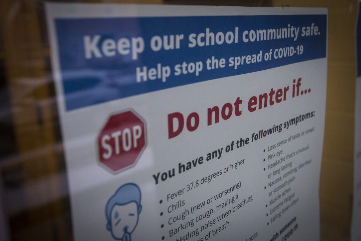 A poster outside a school with information how to stop the spread of COVID-19 in Kingston, Ontario on Wednesday, December 30, 2020, as the COVID-19 pandemic continues across Canada and around the world.