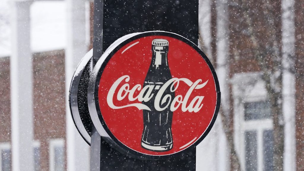 A Coca-Cola sign hangs outside a Coca-Cola distributor, Tuesday, Feb. 9, 2021, in Bedford, Ohio. 