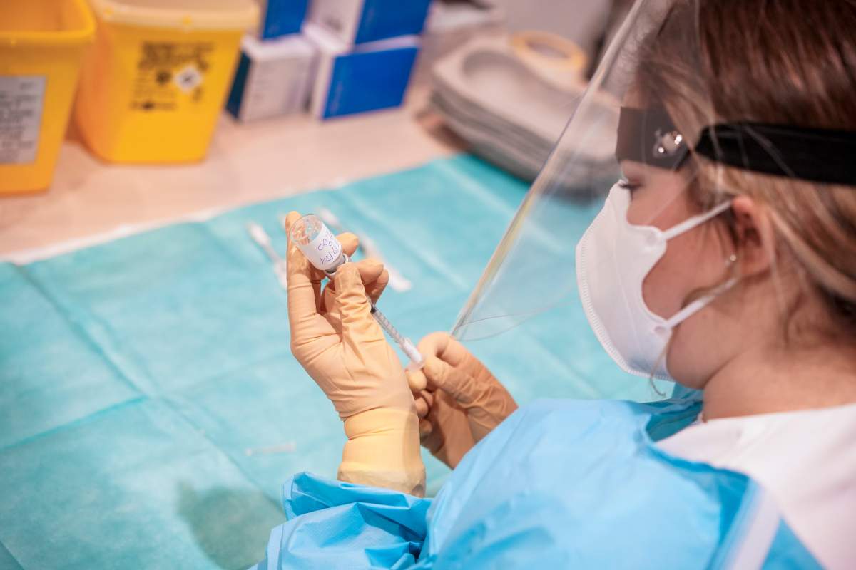A health worker prepares a dose of the Moderna COVID-19 vaccine to be administrated to over eighty-year-olds, at a vaccine center in Rome's Auditorium, Monday, Feb. 15, 2021.