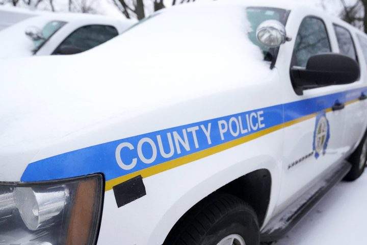 A Baltimore County police SUV is seen covered with snow while parked in a lot, Thursday, Feb. 18, 2021, in Hunt Valley, Md. 