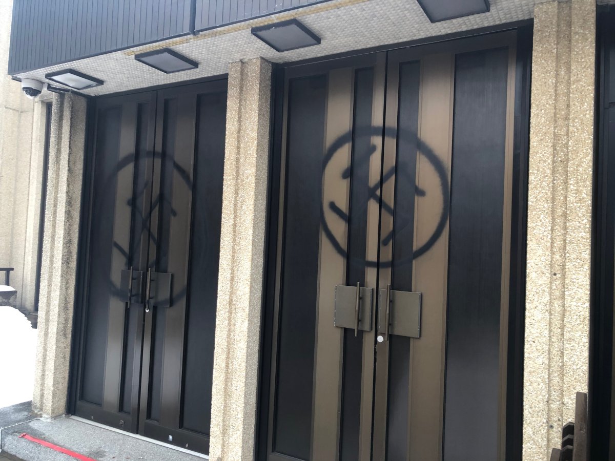 Spray-painted swastikas are shown on the doors of Shaar Hashomayim, one of Montreal's largest synagogues, in a handout photo. A 28-year-old man charged with trying to set fire to a Montreal synagogue has been found not criminally responsible.