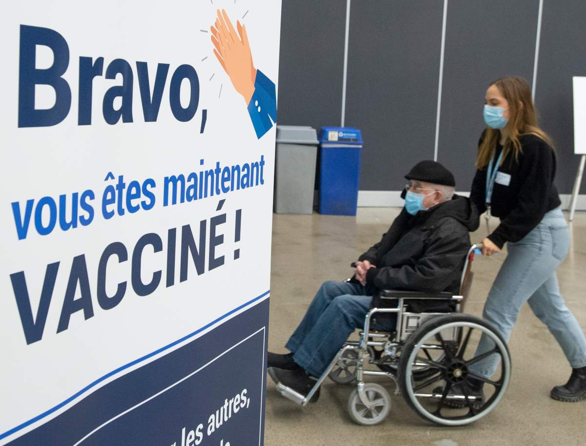 Seniors pass a congratulatory sign after receiving their COVID-19 vaccinations at the Palais de Congress site as Quebec begins mass vaccinations based on age across the province, Monday, March 1, 2021 in Montreal.