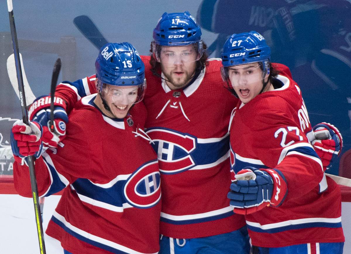 Montreal’s Josh Anderson (17) celebrates with teammates Jesperi Kotkaniemi (15) and Alexander Romanov (27) after scoring against the Winnipeg Jets during first period NHL hockey action in Montreal, Saturday, March 6, 2021.
