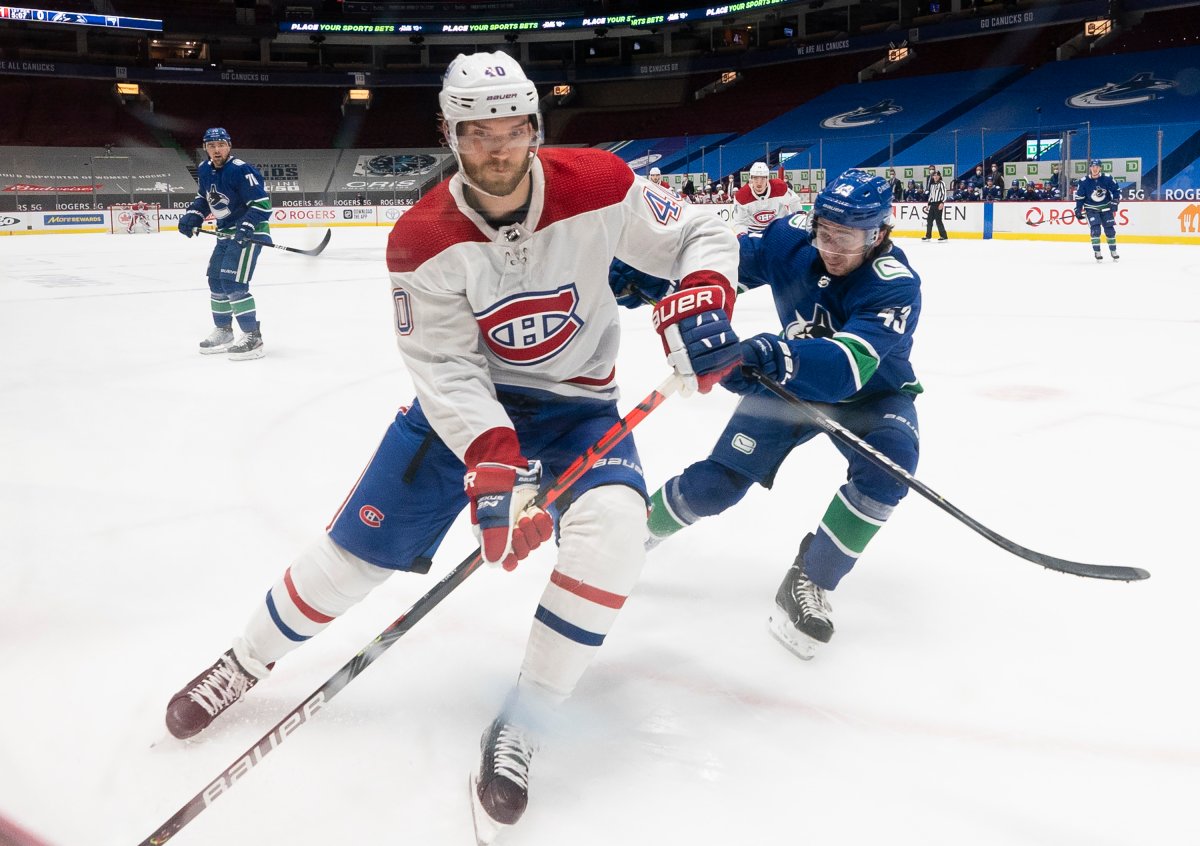 Montreal Canadiens right wing Joel Armia (40) fights for control of the puck with Vancouver Canucks defenceman Quinn Hughes (43) during first period NHL action in Vancouver, Monday, March 8, 2021.