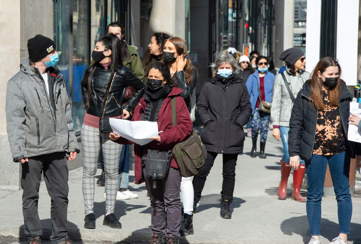 Pedestrians make their way along St. Catherine street, Wednesday, March 10, 2021 in Montreal.