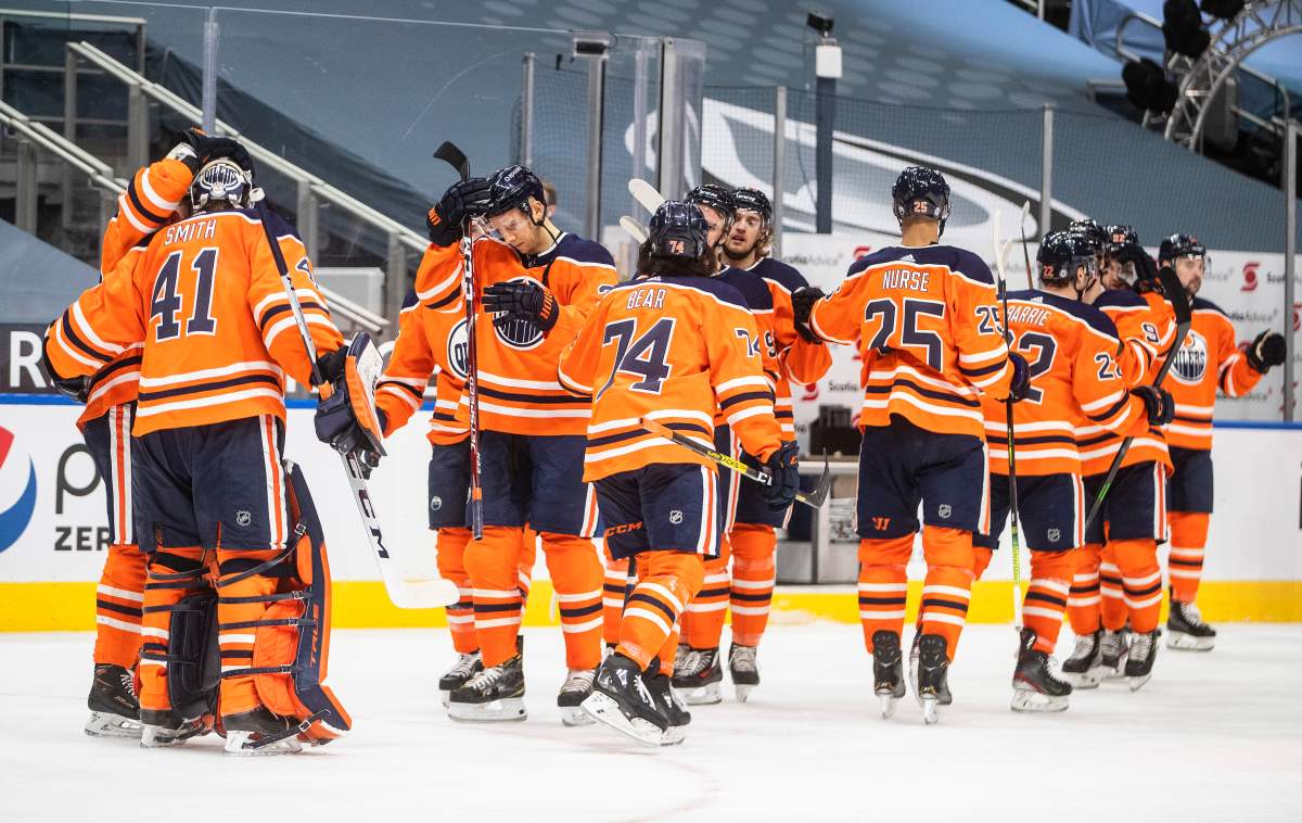 Edmonton Oilers players celebrate the win over the Ottawa Senators during NHL action in Edmonton on Wednesday, March 10, 2021.THE CANADIAN PRESS/Jason Franson.