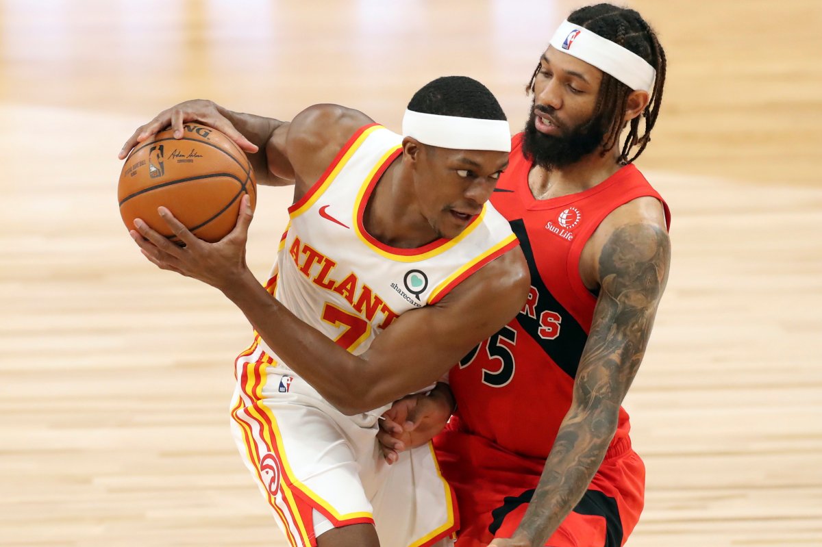 Atlanta Hawks' Rajon Rondo, left, is guarded by Toronto Raptors' DeAndre' Bembry during the first half of an NBA basketball game Thursday, March 11, 2021, in Tampa, Fla. 