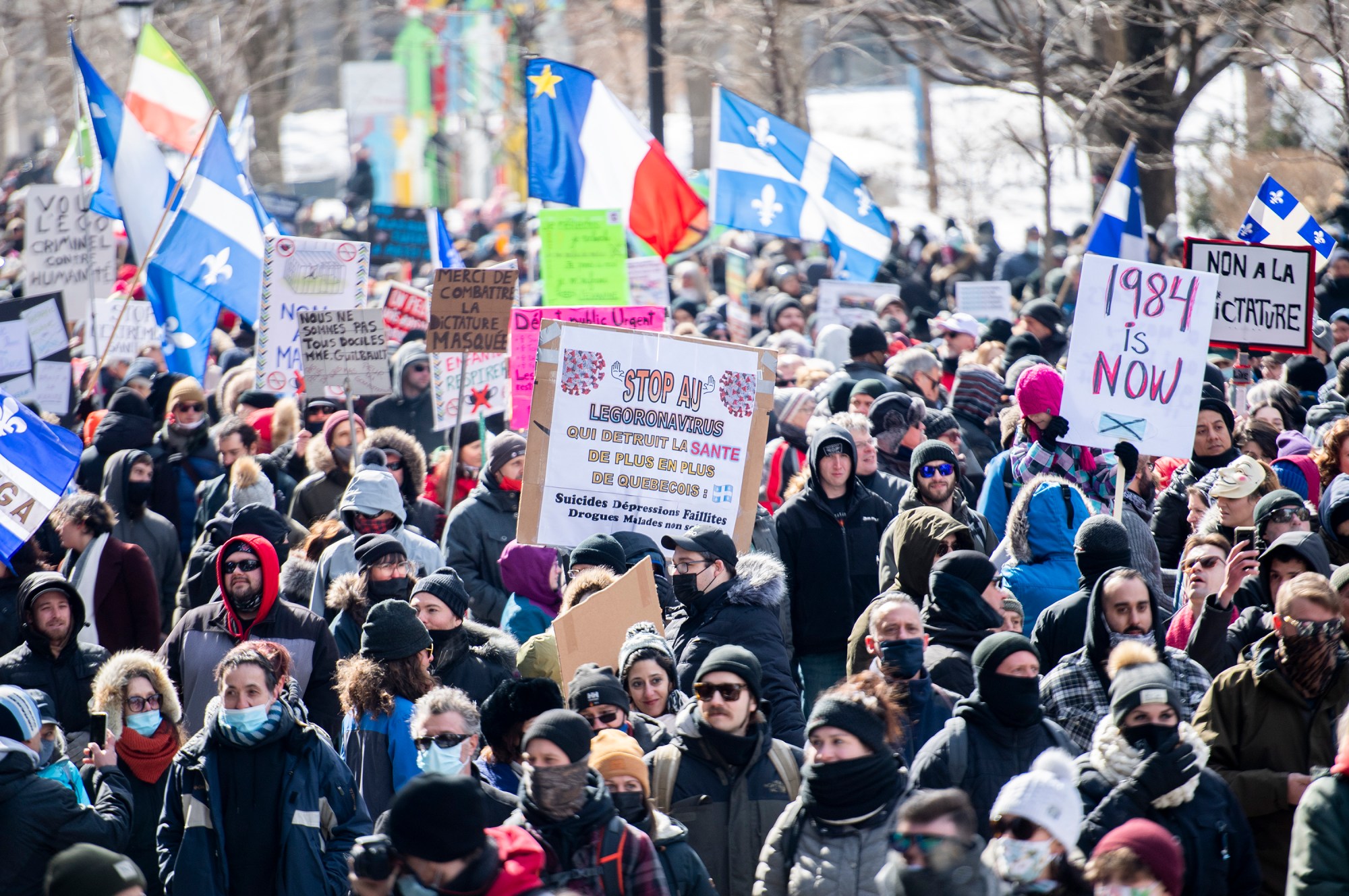 People take part in a demonstration to oppose government restrictions to curb the spread of Covid-19 in Montreal, Saturday, March 13, 2021.