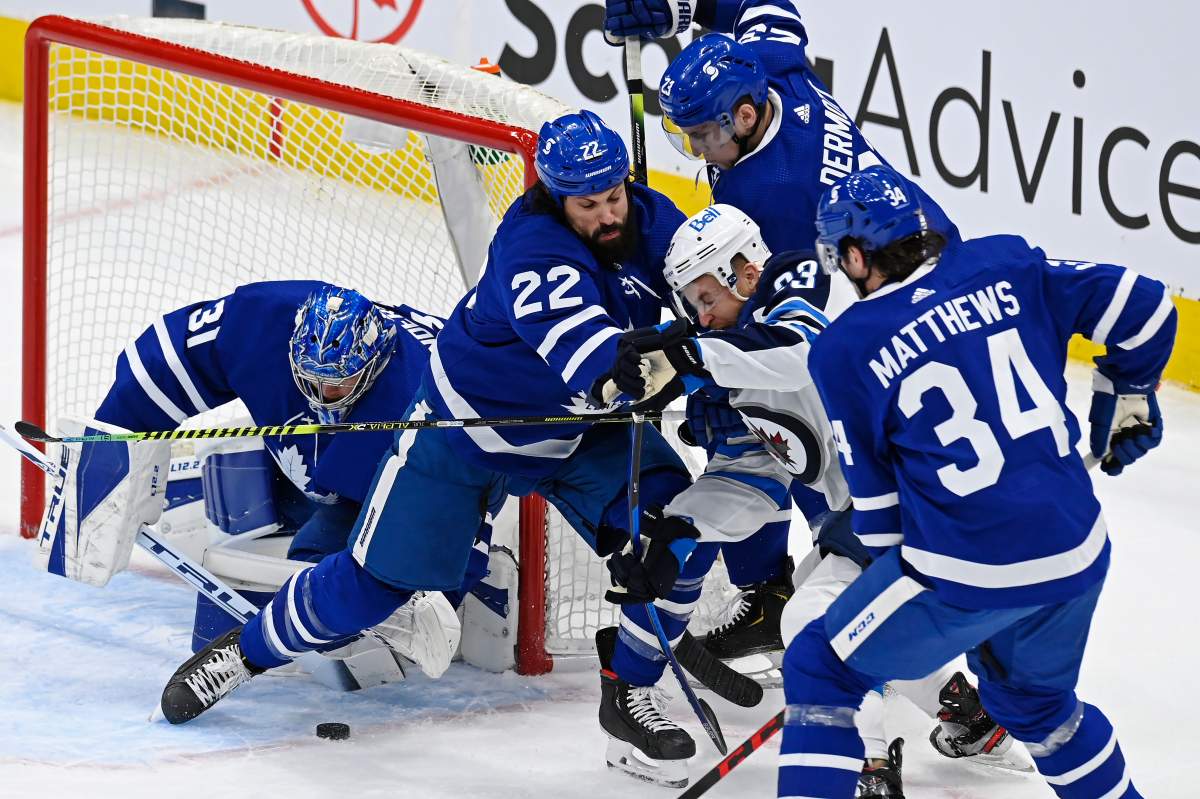 Toronto Maple Leafs goaltender Frederik Andersen (31) looks for the puck as Winnipeg Jets centre Trevor Lewis (23) is surrounded by Maple Leafs’ Zach Bogosian (22), Travis Dermott (23) and Auston Matthews (34) during first period NHL action in Toronto on Saturday, March 13, 2021.