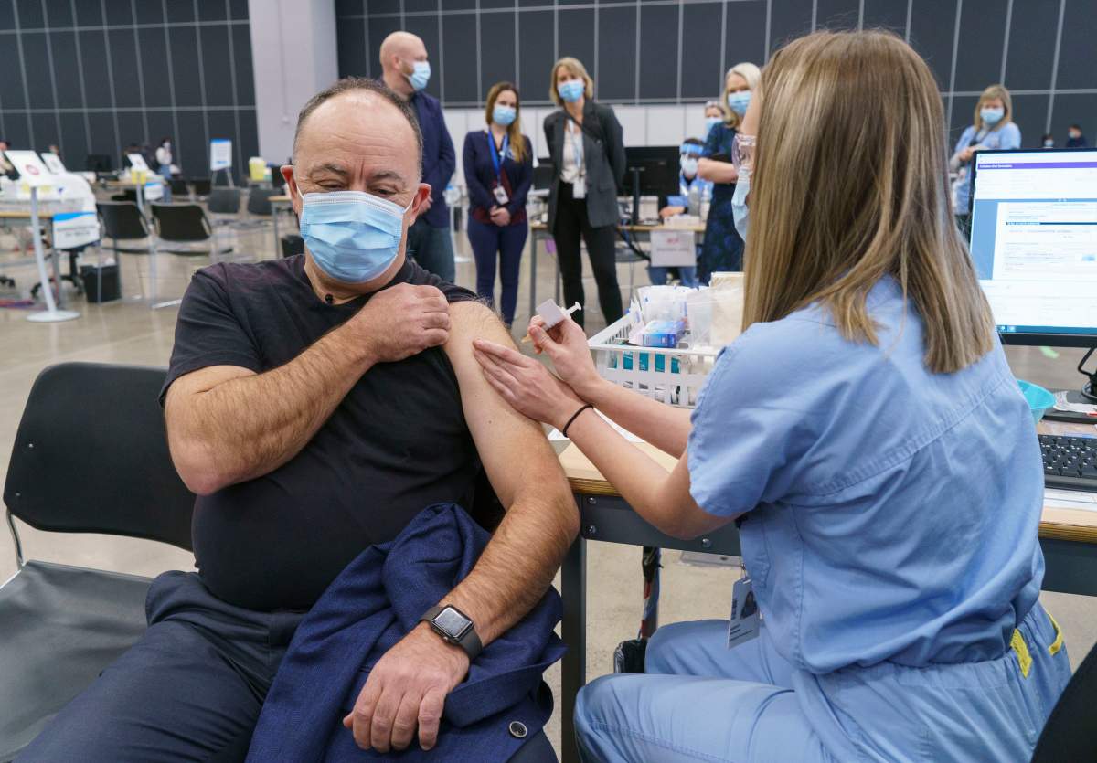 Quebec Health Minister Christian Dube gets his first dose of the COVID-19 vaccine.