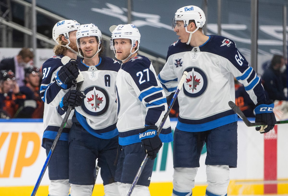 The Winnipeg Jets' Kyle Connor (81), Josh Morrissey (44), Nikolaj Ehlers (27) and Logan Stanley (64) celebrate a goal against the Edmonton Oilers during first period NHL action in Edmonton on Saturday, March 20, 2021.