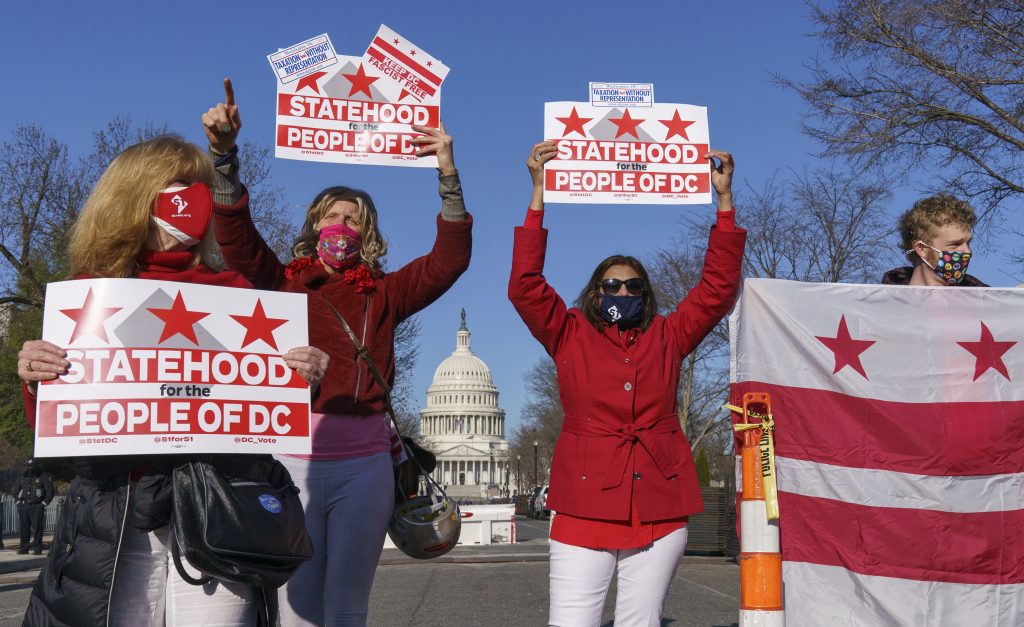 Advocates for statehood for the District of Columbia demonstrate near the Capitol prior to a House of Representatives hearing on creating a fifty-first state, in Washington, Monday, March 22, 2021. The activists were able to gather near the Capitol building after the outer perimeter security fencing was dismantled this weekend. (AP Photo/J. Scott Applewhite).