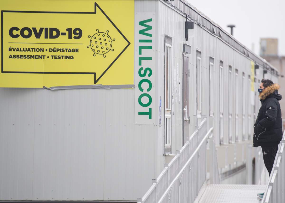 A man waits to be tested for COVID-19 at a clinic in Montreal, Sunday, March 28, 2021, as the COVID-19 pandemic continues in Canada and around the world. 