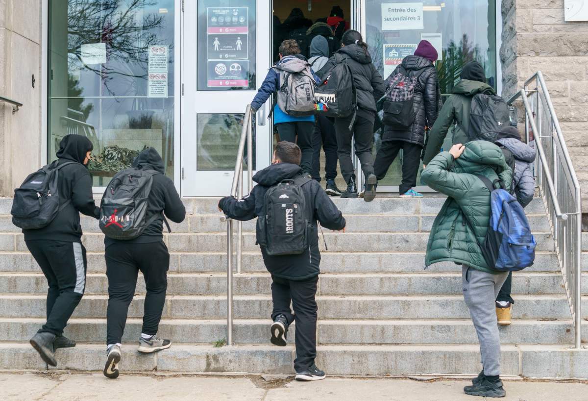 Students enter the Pierre Laporte Secondary School as secondary school students return to class full time during the COVID-19 pandemic in Montreal, on Monday, March 29, 2021.